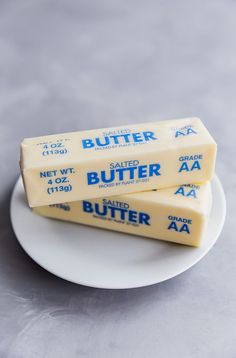 three pieces of butter sitting on top of a white plate