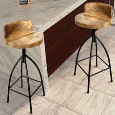 two wooden stools sitting in front of a counter