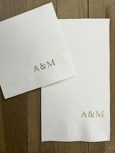 two personalized napkins on top of each other with the word m & a printed on them