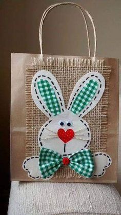 a brown paper bag with a green and white checkered bunny on it's side