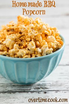 homemade bbq popcorn in a blue bowl on a white wooden table with text overlay