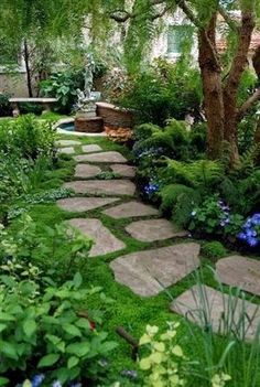 a stone path in the middle of a garden