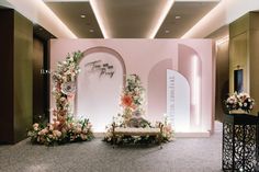 a room decorated with flowers and an arch