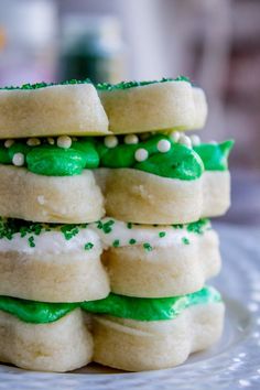 a stack of green and white cookies on a plate