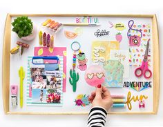 a person's hand is pointing at an assortment of items on a white board