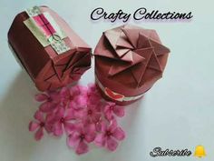 two origami boxes with pink flowers on them