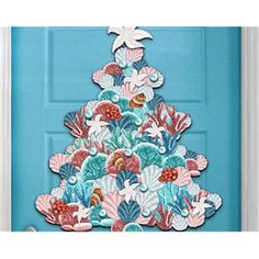 a blue door with a christmas tree cut out of paper on the front and side