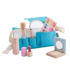 a blue bag filled with lots of different types of items next to a small mirror