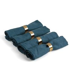 four folded towels with gold rings on them