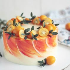 a cake with oranges and leaves on it