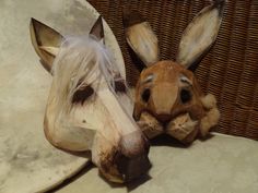 two wooden donkey heads sitting next to each other