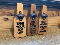 three wooden bottle openers with the words take your beer to an open heart on them