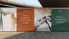 a man is walking his dog in front of a billboard