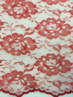 an image of red lace with flowers on it