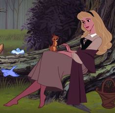 there is a woman that is sitting in the woods with a squirrel on her lap