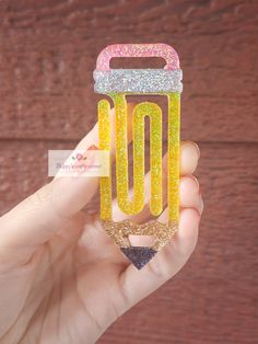 a hand holding up a plastic case with glitter on the bottom and an o logo