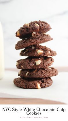 cookies stacked on top of each other in front of a glass of milk with the words nyc style white chocolate chip cookies