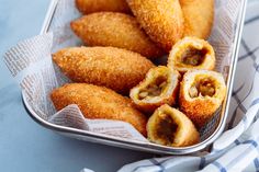 some fried food in a basket on a blue and white checkered table cloth,