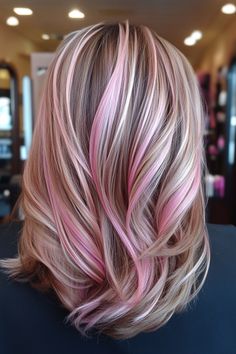 Medium-length brown hair with pink highlights in a salon setting. Light Pink And Blonde Highlights In Brown Hair, Blonde W Pink Highlights, Peekaboo Highlights Blonde, Pink Peekaboo Highlights Blonde, Blond With Pink Highlights, Light Pink Streaks In Blonde Hair, Pink Blonde Highlights, Neopolitan Hair Highlights