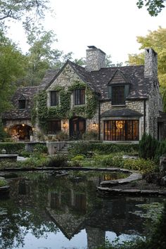 a large house sitting next to a pond