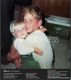 an old photo of a young boy hugging his younger brother in front of the camera