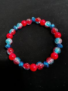 Cystal cut dark blue bead, Red bead bracelet with blue and red cracked color bead,gives it a very patriotic feel to it,jewelry cord ,One of a kind. Item comes with a mesh bag for gift giving. Red Bead Bracelet, Red Beaded Bracelet, Crystal Bead Jewelry, Blue Jewelry, Bead Jewelry, Red Bead, Mesh Bag, Blue Beads, Bead Bracelet