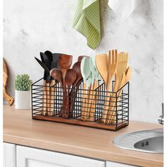 utensils and spoons in a metal basket on a counter