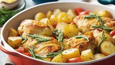 a casserole dish filled with potatoes, tomatoes and rosemary garnishes