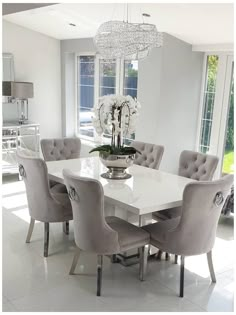 a dining room table with chairs and a chandelier