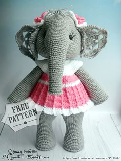 an elephant wearing a pink and white dress with a free pattern on it's chest