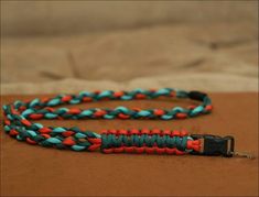 an orange and blue braided cord on a bed