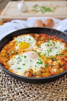 two fried eggs are in a skillet on the table