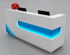 a white reception table with blue lights on the front and back sides, in an office setting