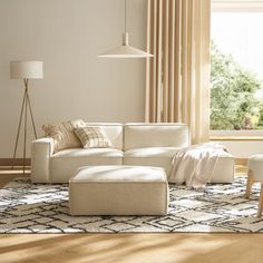 a living room with a white couch and two lamps on either side of the couch