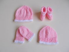 three knitted baby hats and two matching mittens