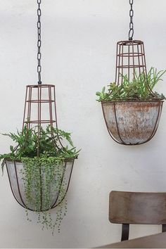 two hanging planters with plants in them