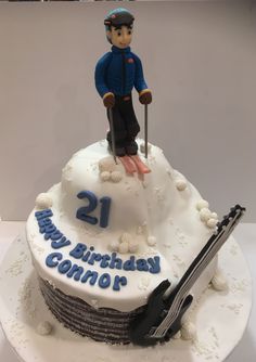 a birthday cake with a skier on top