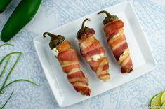 bacon wrapped jalapenos on a white plate