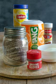 ingredients to make orange cake sitting on a cutting board next to an empty glass jar