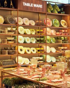 a display case filled with lots of different types of food on plates and bowls next to each other