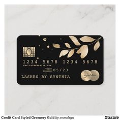 a black credit card with gold leaves on it