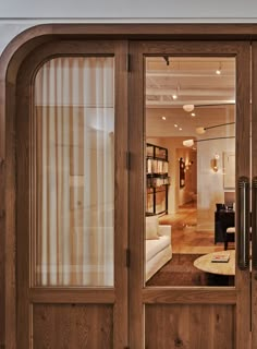 an open wooden door leading to a living room