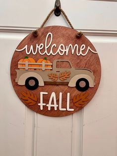 a wooden sign that says welcome fall with a truck and pumpkins on the front