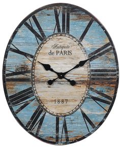 a wooden clock with the words de paris painted on it's face and hands