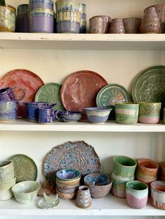 many plates and bowls are on the shelves