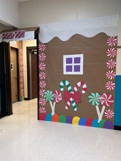 a classroom door decorated with candy canes and gingerbread house on the side wall