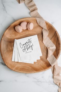 some eggs are sitting on top of a wooden plate with napkins in front of it