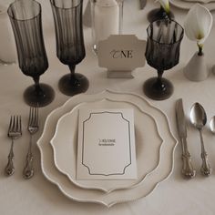 a table set with silverware and place settings