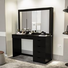 there is a vanity with a mirror and lights on the wall in this room,