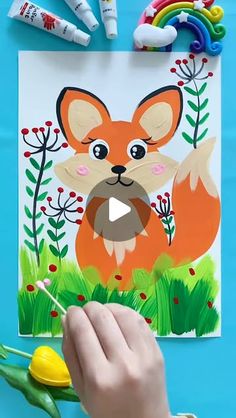 someone is painting a picture of a fox in the grass with crayons and markers